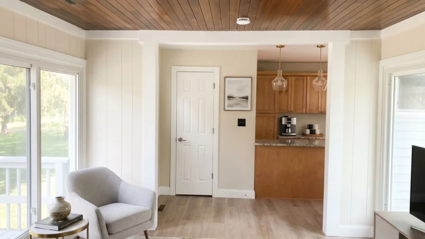 A brightly-lit, modern living room, with wooden cabinets and wood panel ceilings.